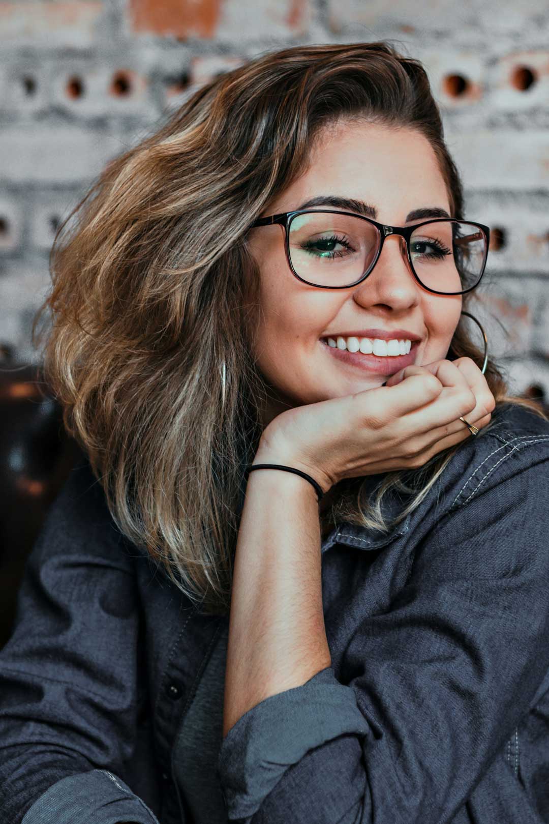 Young lady smiling wearing large eyeglasses frame