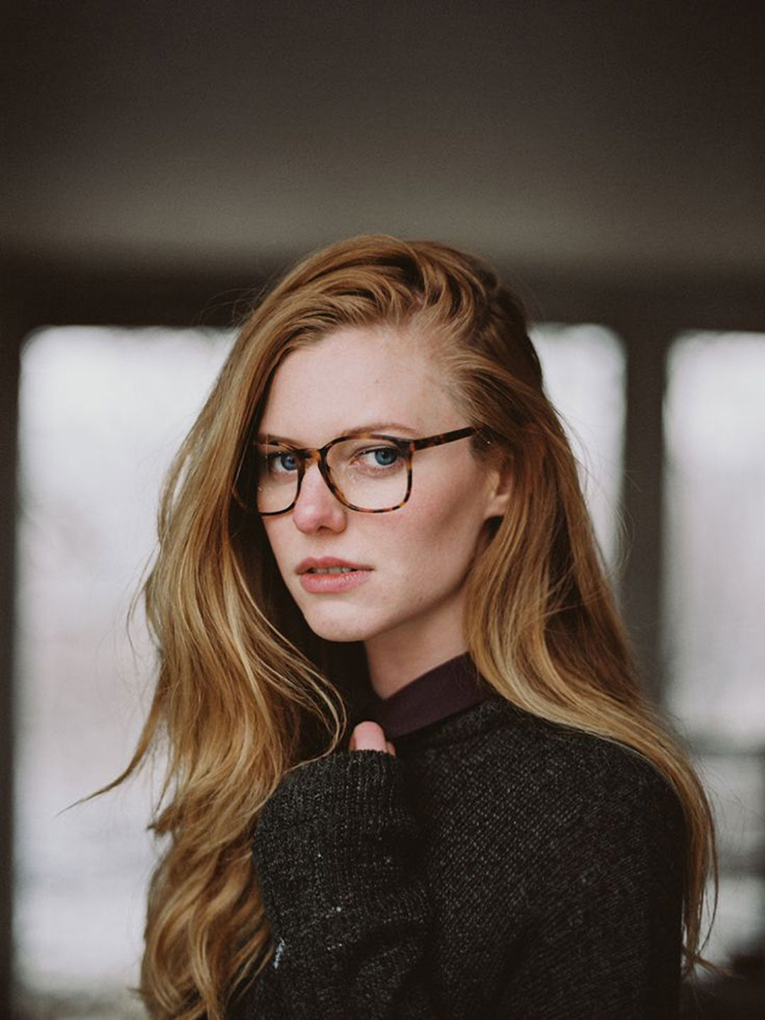 Young lady with long auburn hair and eyeglasses