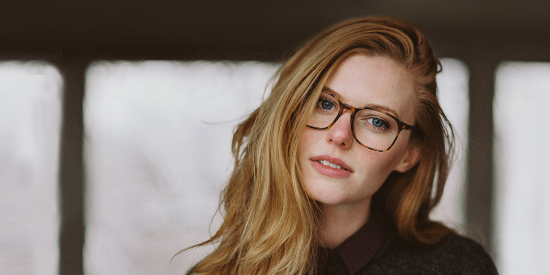 Young woman with blonde hair wearing tortoise shell eyeglasses frame