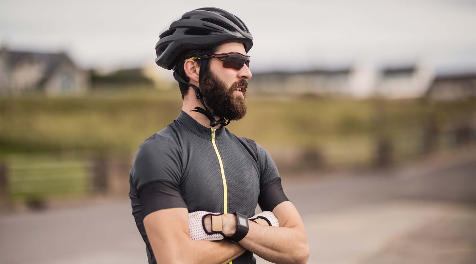 athlete standing with his arms crossed wearing sunglasses