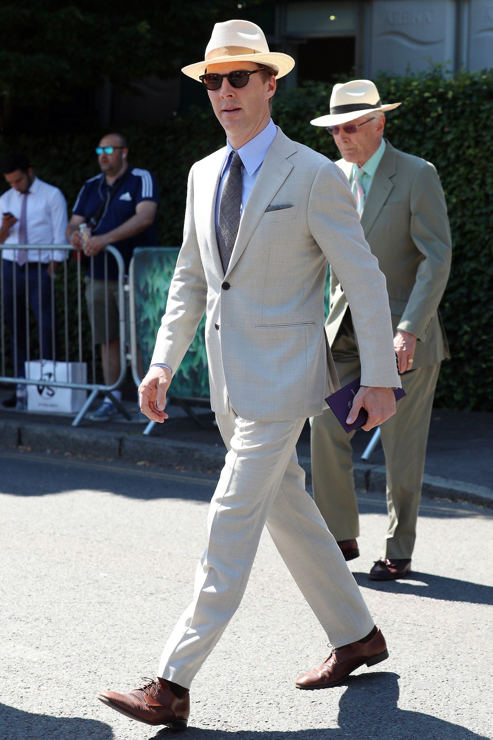 Benedict Cumberbatch in light grey suit, white hat and stylish sunglasses