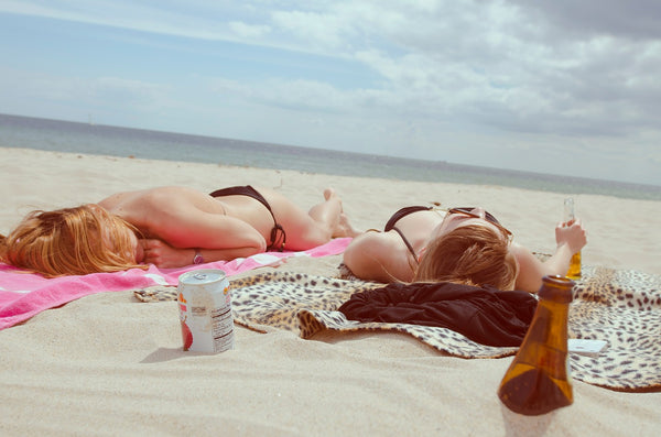 two women tanning on a beach