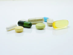 vitamin pills on white background