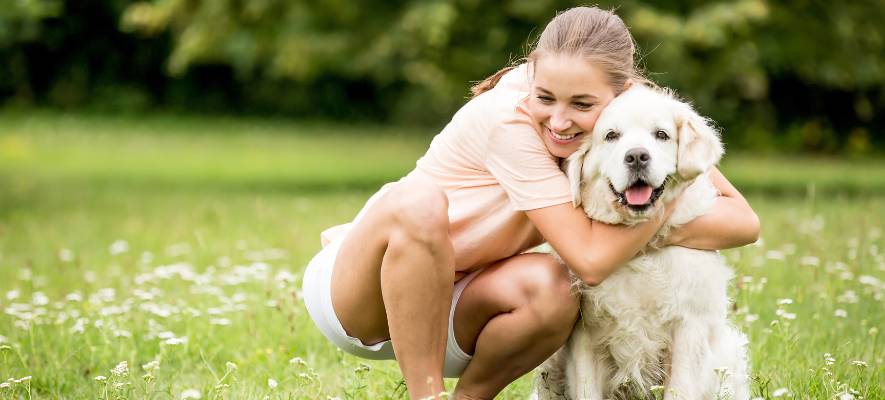 girl hugging dog