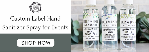 custom label hand sanitizer spray for weddings and bridal showers 3 bottles that say the bride and grooms name and wedding date in lavender peppermint or white thyme essential oils for guest pictured in front of eucalyptus foliage sprigs and branches handmade.