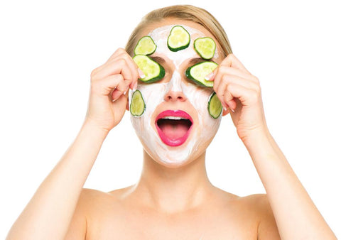 woman using cucumbers and facial mask to heal cracked skin