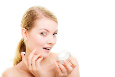 woman moisturizing to treat dry facial skin