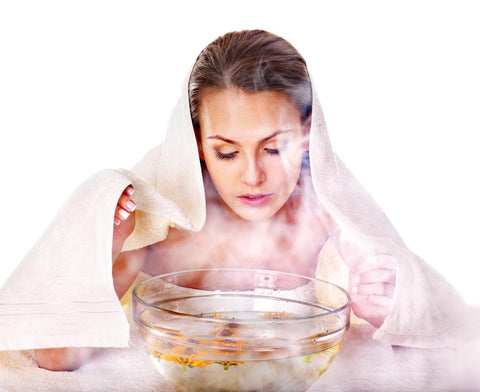 woman doing a steaming at-home facial