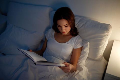 woman reading in bed at night