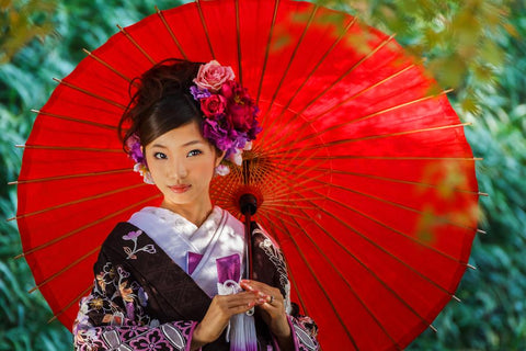 Beautiful Japanese woman holding a bright umbrella  