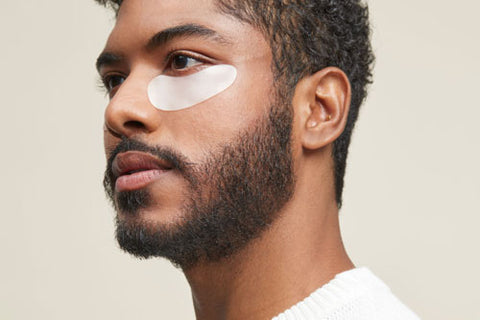man wearing skincare eye patches