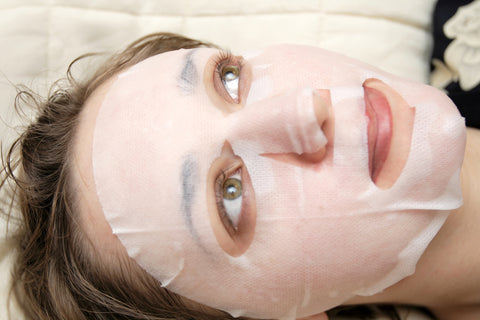 woman relaxing and enjoying sheet mask benefits