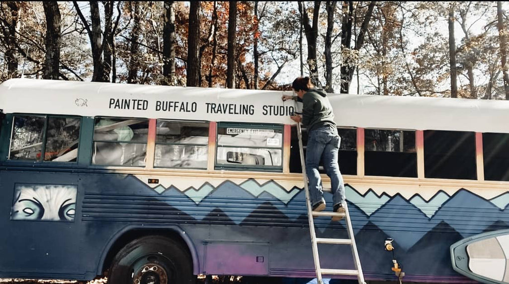 Jessica Rambo painting the outside of her bus