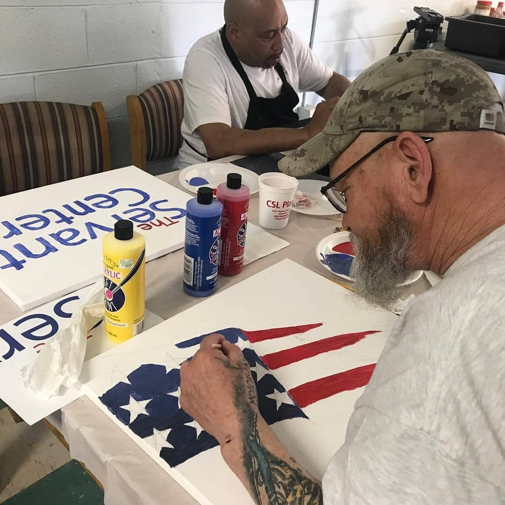 painted buffalo traveling studio with veterans doing art