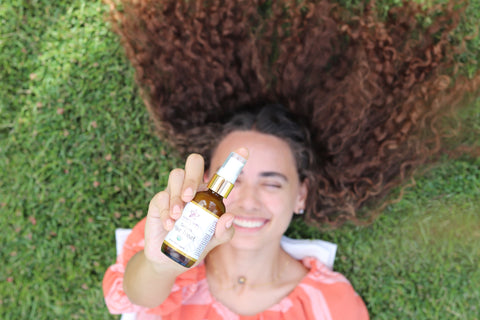 Girl Holding The Honey Girl Organics Serum Hair Treat