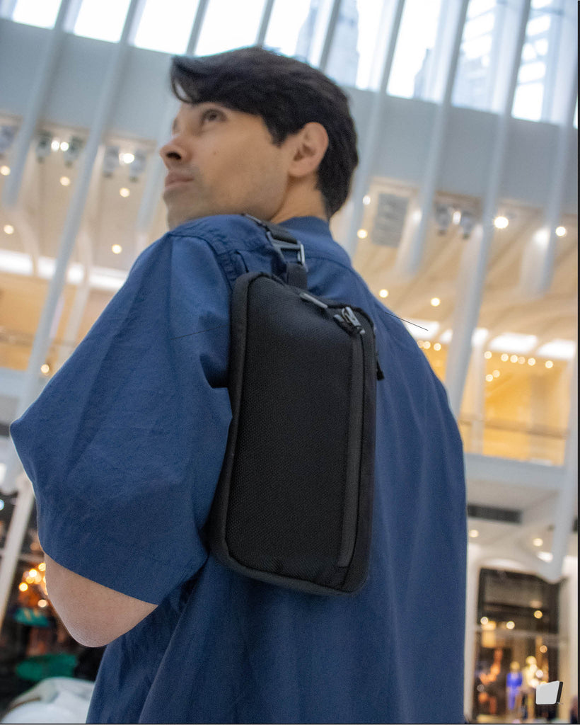 AUX Pocket minimalist EDC bag with clutch strap.