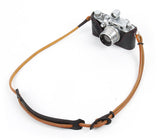 How to adjust an adjustable neck strap. Dark brown leather buckle on light brown adjustable neck strap.