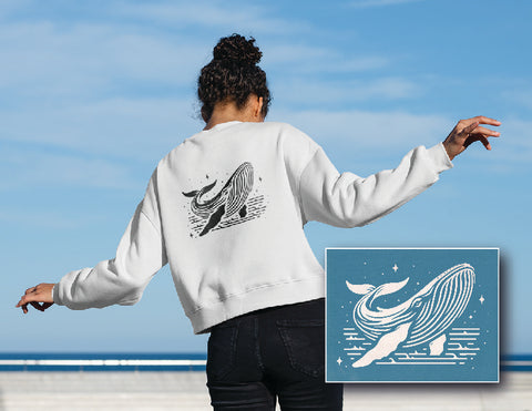 Girl on beach wearing whale print sweater, using whale print downloadable file