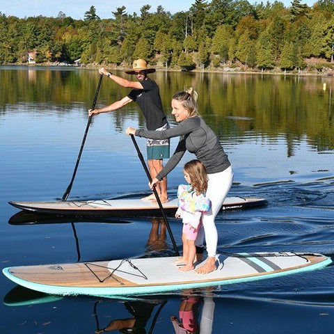 A family of stand up paddle boarders