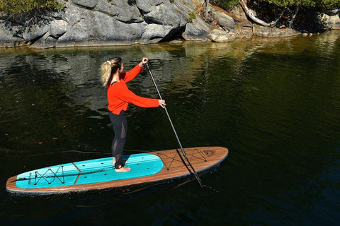 Female Paddle Boarder on a Lake