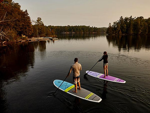 stand up paddle boarders on a lake
