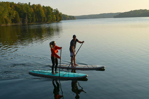 Young Couple on stand up paddle board