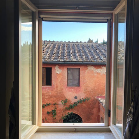 Tuscan Style Home Décor: A Guide The 5 Main Things to Know - A colorful view from the kitchen in the house where I stayed on my recent buying trip in Italy