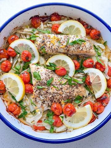 Oven-baked fish with fennel, cherry tomatoes and lemon