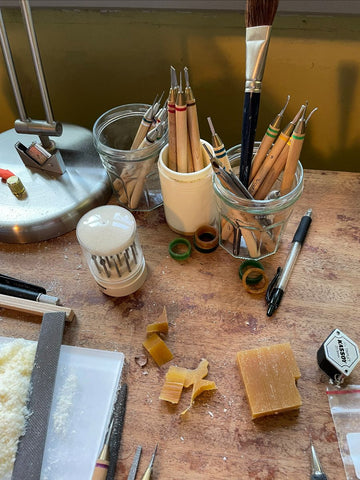 A jeweler's bench with wax and wax carving tools.