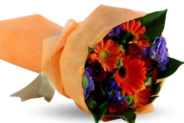 Fire orange and red Gerberas, red roses and seasonal foliage