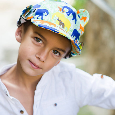 Child wearing cap with ears printed in animal print as featured on little hotdog watson blog