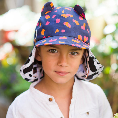 child wearing classic baseball cap with a child-friendly roll-up neck protector as featured on little hotdog watson blog