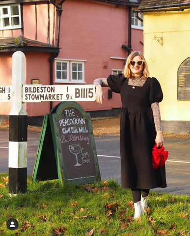 Emma Paton leaning on a sign
