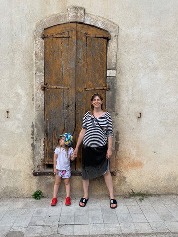 Mother and daughter stood in front of doorway