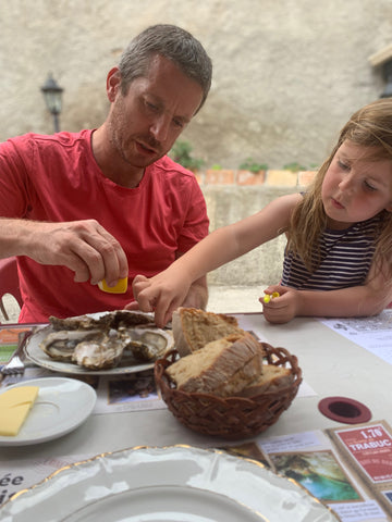 Father and daughter trying oysters