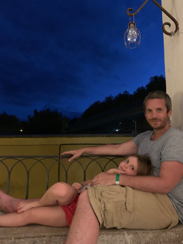 Father and daughter on the balcony looking at the stars