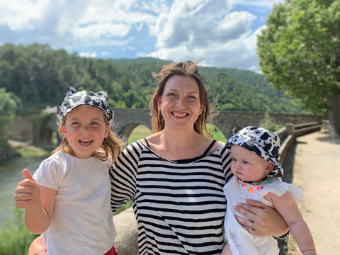 Emma Watson and her two daughters all wearing black and white and Little Hotdog Watson sun hats