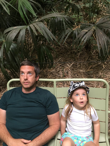 Father and daughter sat on a bench in Anduze