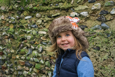 Child in winter hat moose print