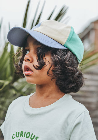 Child wearing baseball hat with built in mosquito protection