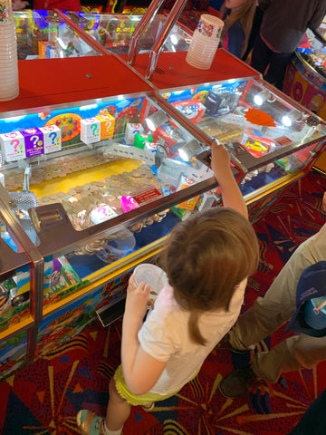 Child playing on Cromer arcade 2p machines