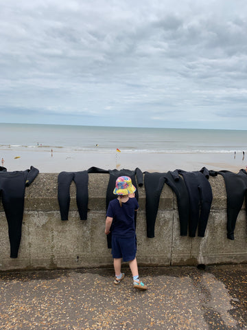 Child wearing Little Hotdog Watson sun hat at Cromer beach