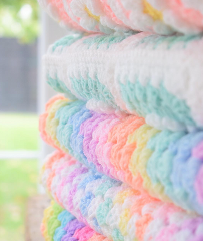 Knitted rainbow blanket for babies, handmade by flora fairweather