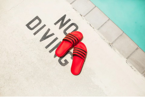 Red slider sandals by the pool