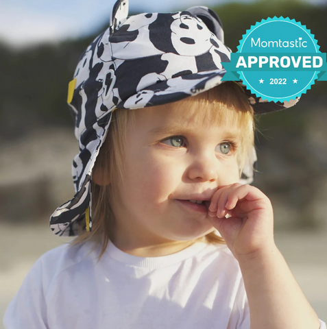 Child wearing Little Hotdog Watson sun hat with the Momtastic stamp of approval award on it