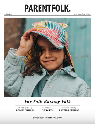 Child wearing Little Hotdog Watson's sun hat in tropical leaf on cover of parent folk magazine