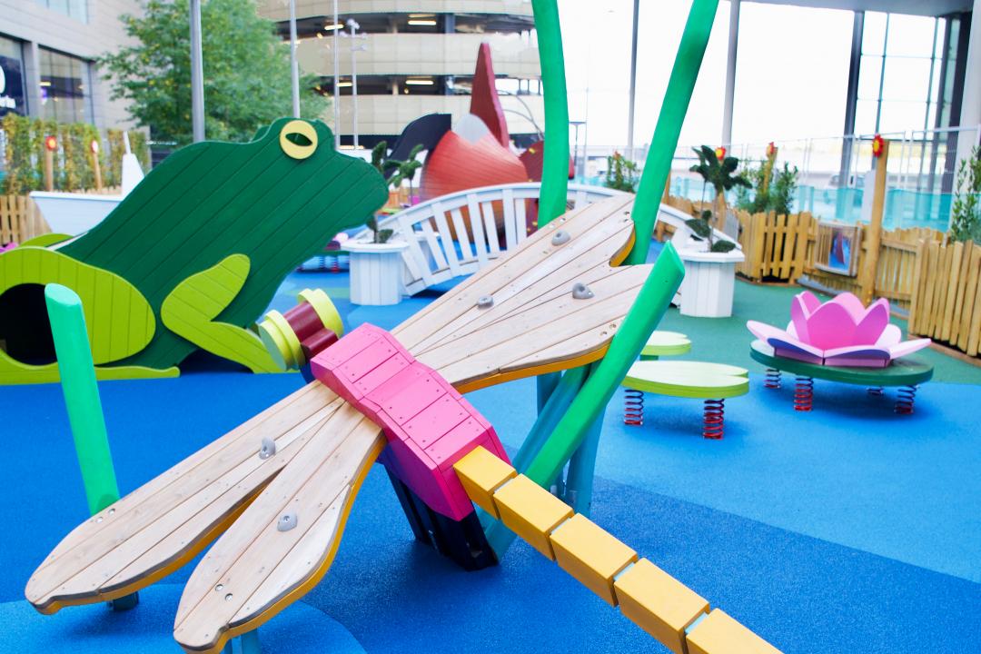 A children's playground with large, colourful, wooden animals at The Pond Westfield, London, United Kingdom