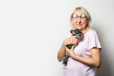 Elderly woman holding her pet chinchilla