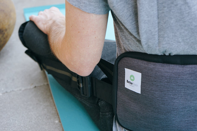 Betterback person sitting on floor