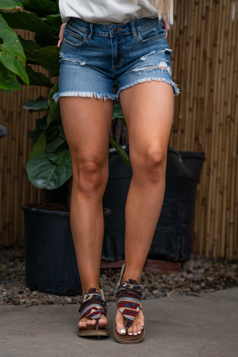 Cello Jeans  Cello's classic boyfriend short is made from rich dark wash denim in a high-rise fit. Cut to a perfect length with frayed hems. Topped with a zipper fly and 5-pocket detailing. Color: Dark Blue Wash  Cuffed Hem Mom Fit Cut: Shorts, 4.75" Inseam Rise: High Rise, 10" Front Rise 99% Cotton 1% Spandex Fly: Zipper Style #: WV45225BF-TD Contact us for any additional measurements or sizing. 